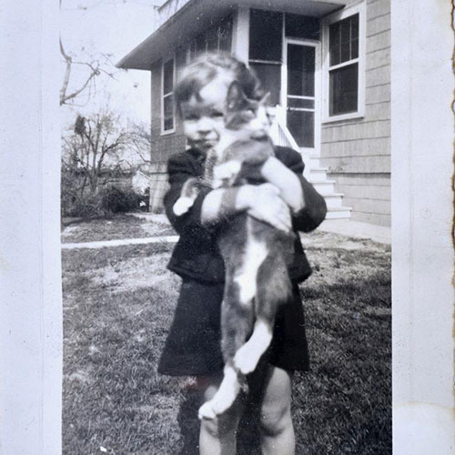 Bernadette as a child holding a cat
